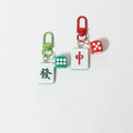 Mahjong tile keychains with dice charms