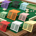 Foldable mahjong card stands in nine colors on a green mahjong table